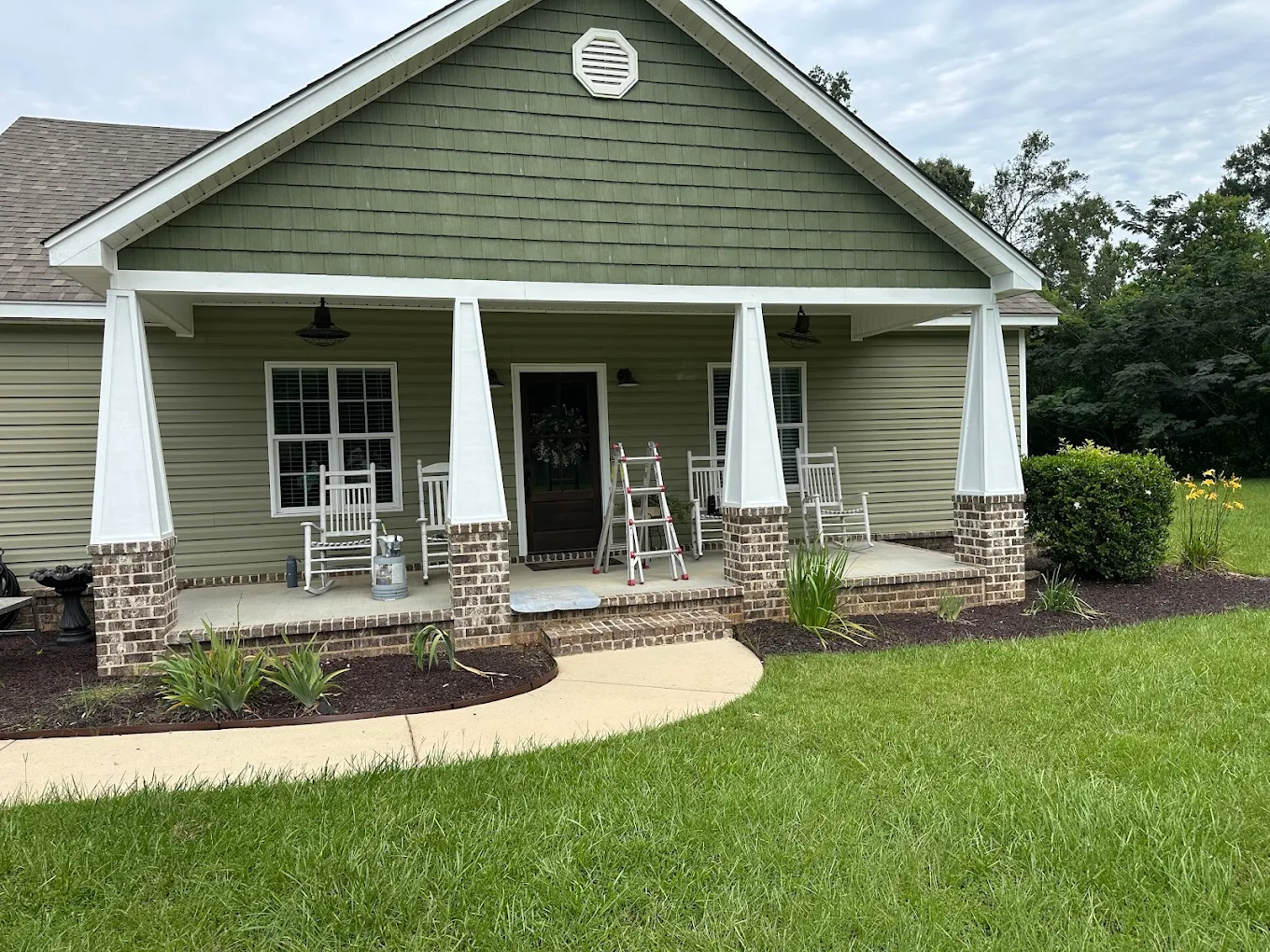 A freshly painted craftsman home with a finished front porch
